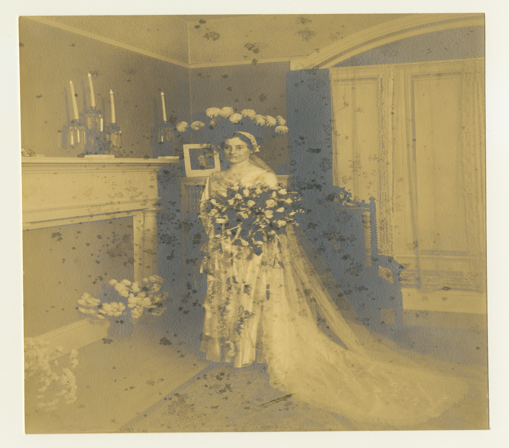 Katherine Stoffregen in her wedding dress and veil with a bouquet